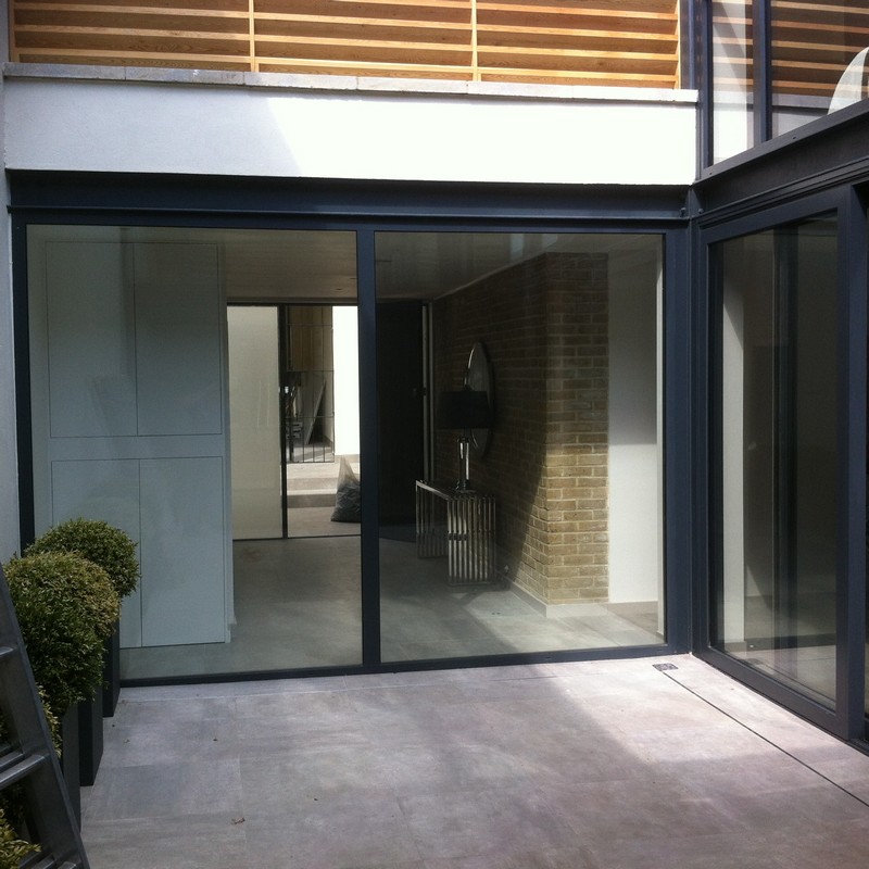 Floor-to-ceiling sliding doors opening to courtyard in Witney