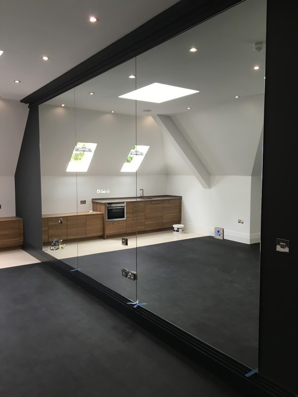 Frameless glass partition in loft conversion by Witney glaziers