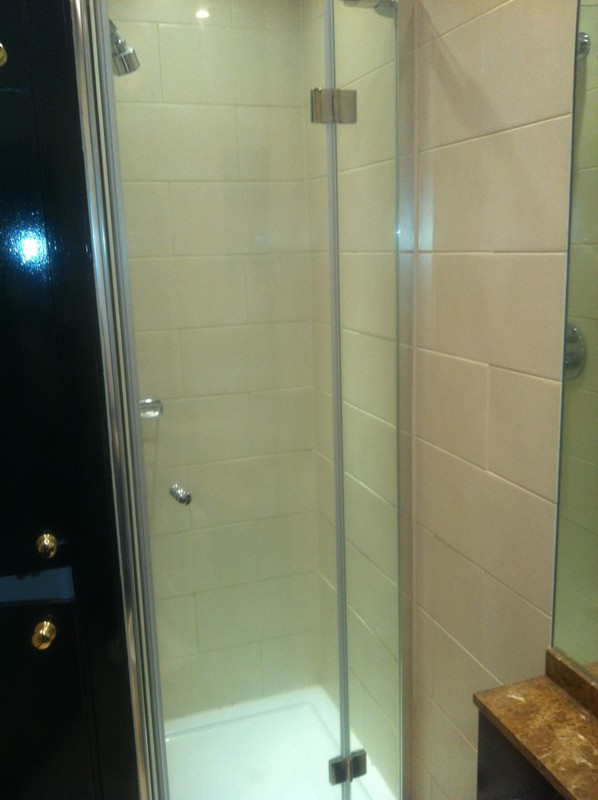 Frameless glass shower enclosure with chrome fittings in Witney